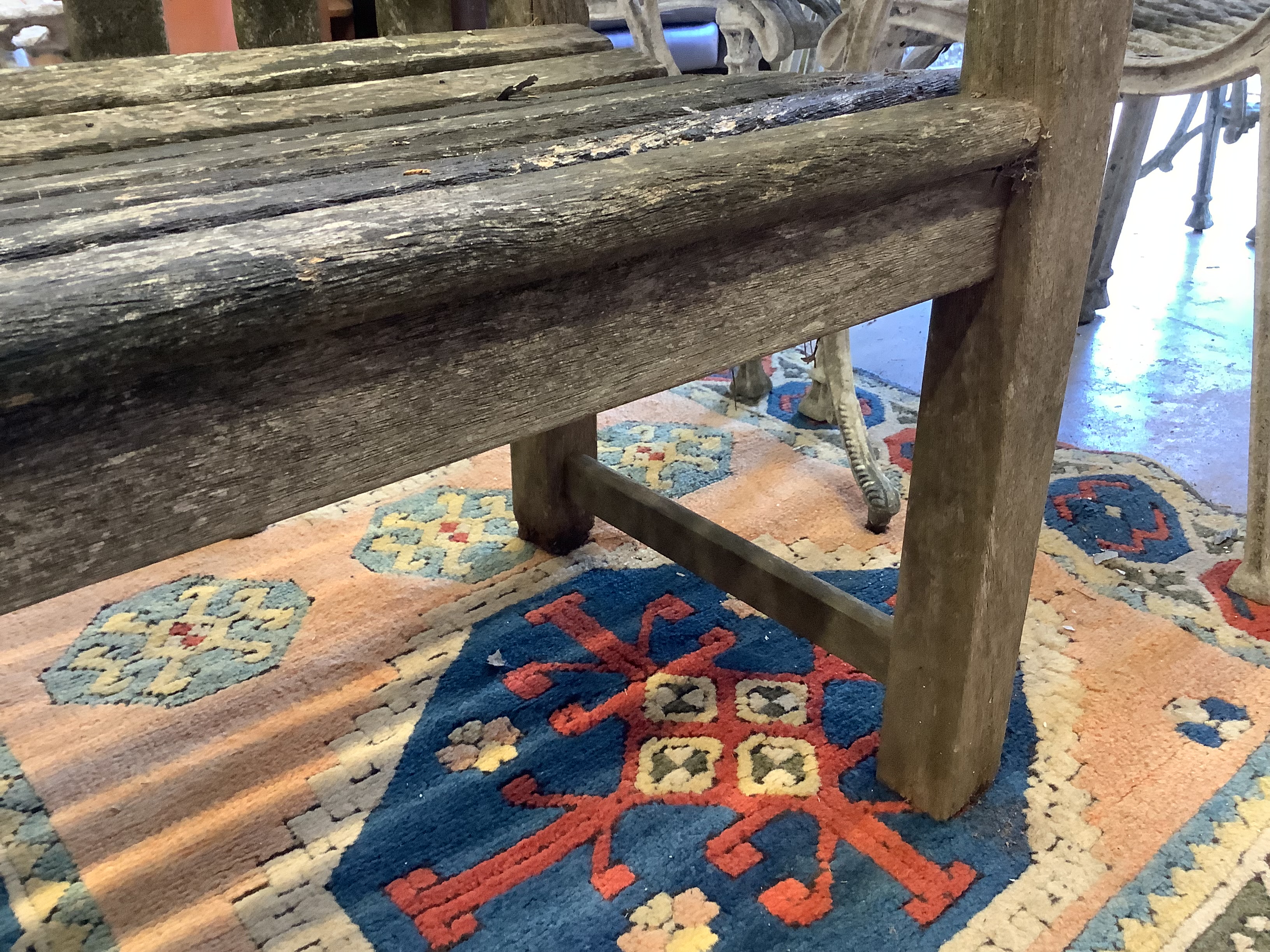 A weathered teak garden bench, length 155cm, depth 57cm, height 98cm